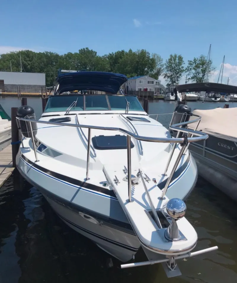 Slide: The Image of 1988 Formula 29 PC boat docked at marina, featuring sleek design and spacious deck. - 43