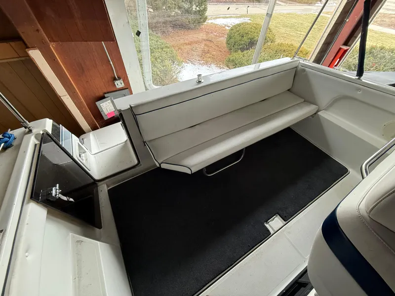 Slide: The Image of 1988 Formula 29 PC boat interior with white seating and black flooring. - 5
