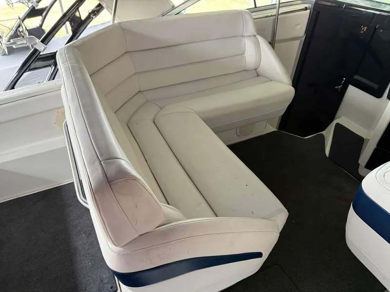 Slide: The Image of 1988 Formula 29 PC boat interior with white cushioned seating. - 6