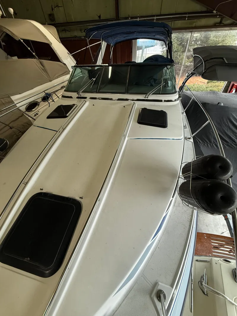 Slide: The Image of 1988 Formula 29 PC boat with blue canopy, docked indoors. - 9