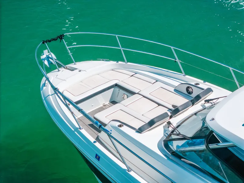 Slide: The Image of 2021 Jeanneau Leader 12.5 WA boat with spacious sunbathing area on turquoise water. - 11