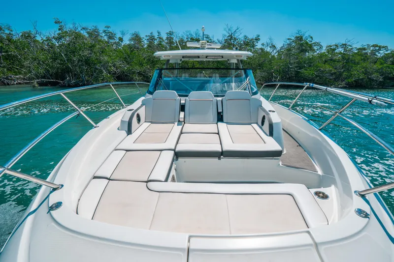 Slide: The Image of 2021 Jeanneau Leader 12.5 WA boat with spacious deck and seating, cruising in clear waters. - 13