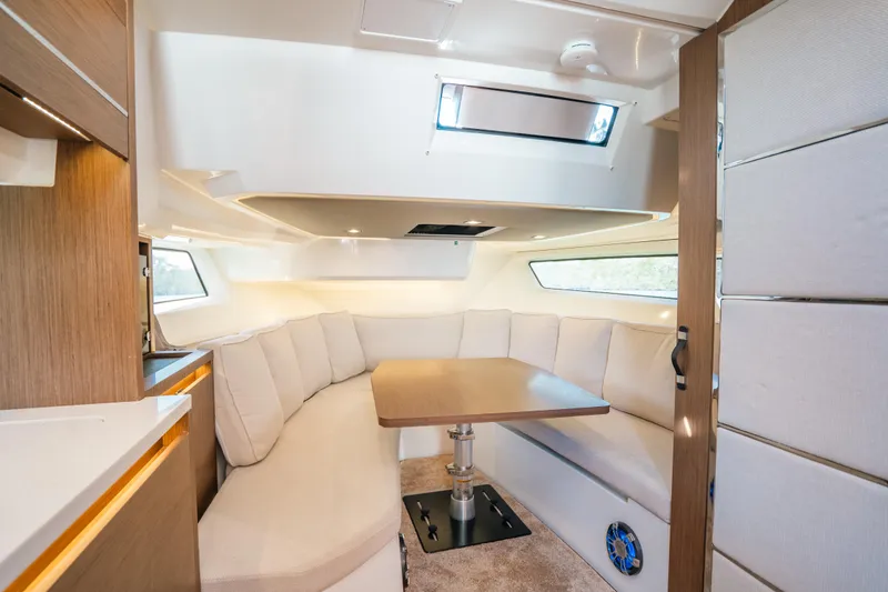 Slide: The Image of Interior of 2021 Jeanneau Leader 12.5 WA with cozy seating and table. - 15