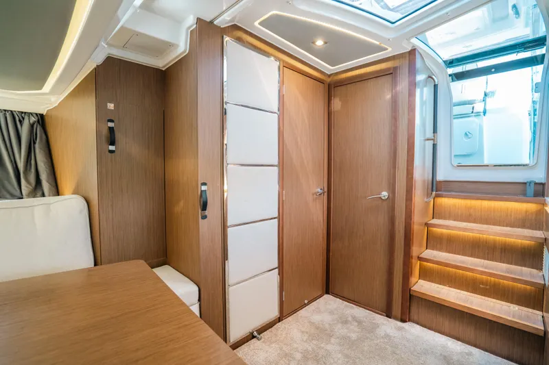 Slide: The Image of Interior of 2021 Jeanneau Leader 12.5 WA, featuring modern wood finishes and elegant lighting. - 16