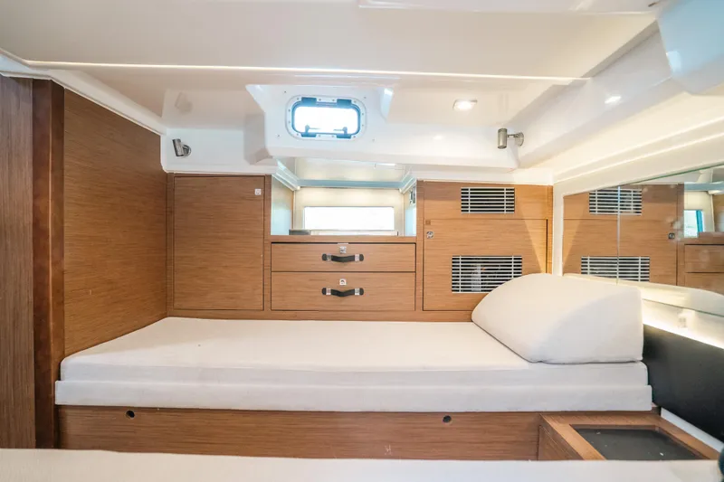 Slide: The Image of 2021 Jeanneau Leader 12.5 WA cabin interior with wooden finish and comfortable bedding. - 23