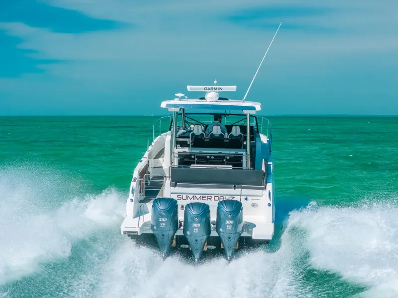 Slide: The Image of 2021 Jeanneau Leader 12.5 WA cruising on turquoise waters, rear view. - 25