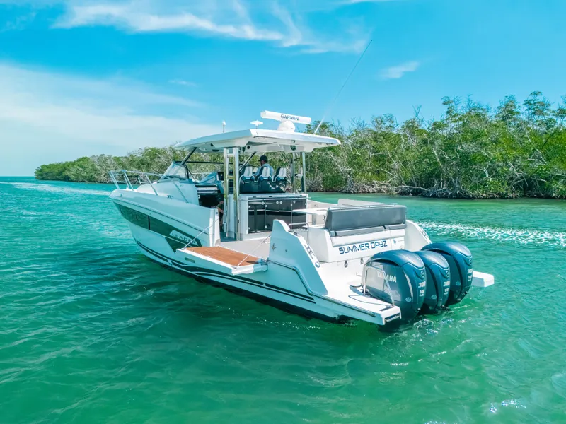 Slide: The Image of 2021 Jeanneau Leader 12.5 WA cruising on clear blue water. - 26