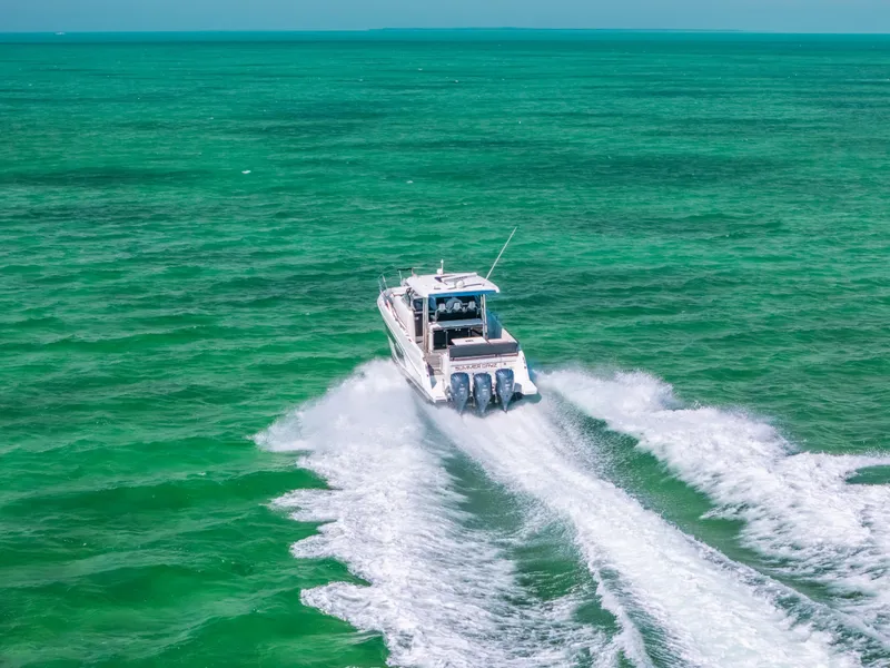 Slide: The Image of 2021 Jeanneau Leader 12.5 WA cruising on vibrant turquoise waters. - 29