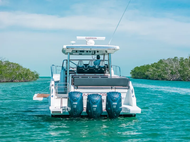 Slide: The Image of 2021 Jeanneau Leader 12.5 WA boat with triple 300 HP engines on turquoise water. - 4