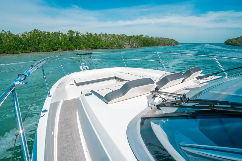 Slide: The Image of 2021 Jeanneau Leader 12.5 WA cruising on turquoise waters with lush greenery. - 6