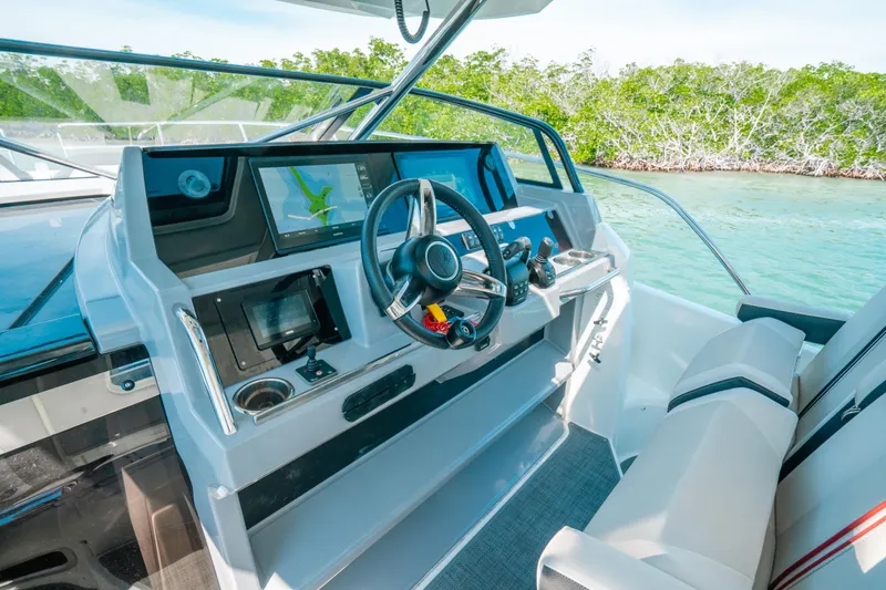 Slide: The Image of 2021 Jeanneau Leader 12.5 WA helm with modern navigation system and comfortable seating. - 7