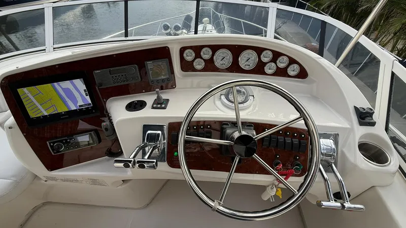 Slide: The Image of 2001 Silverton 410 Sport Bridge helm with navigation instruments and steering wheel. - 15