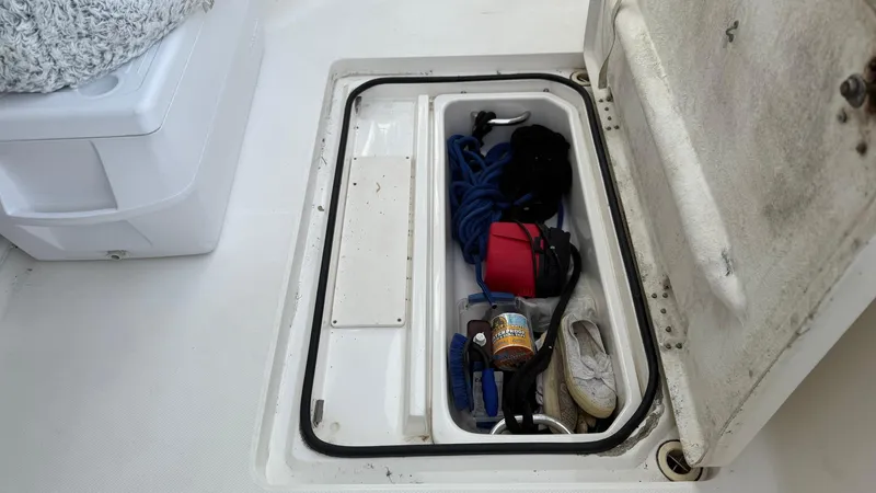 Slide: The Image of Storage compartment on a 2001 Silverton 410 Sport Bridge with various boating gear. - 21