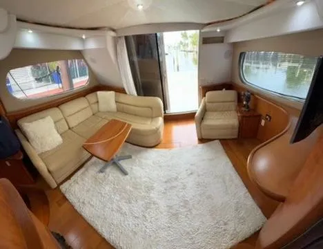 Slide: The Image of Interior of 2001 Silverton 410 Sport Bridge yacht with beige seating and wooden accents. - 25