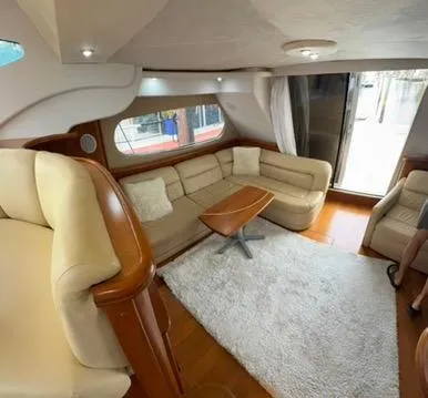 Slide: The Image of Interior of 2001 Silverton 410 Sport Bridge with beige seating and wooden accents. - 27