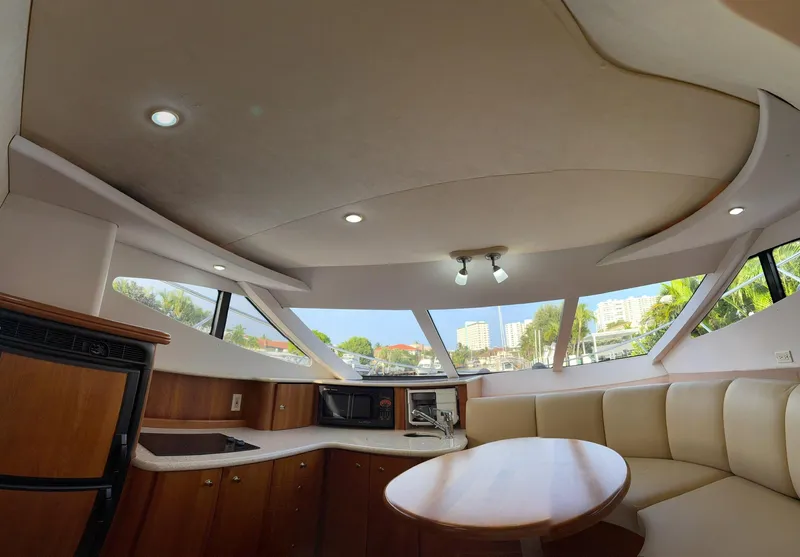 Slide: The Image of Interior of 2001 Silverton 410 Sport Bridge yacht with modern kitchen and seating area. - 31