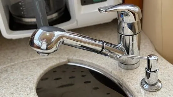 Slide: The Image of Chrome faucet in the kitchen of a 2001 Silverton 410 Sport Bridge yacht. - 34