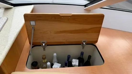 Slide: The Image of Storage compartment with bottles on a 2001 Silverton 410 Sport Bridge yacht. - 35
