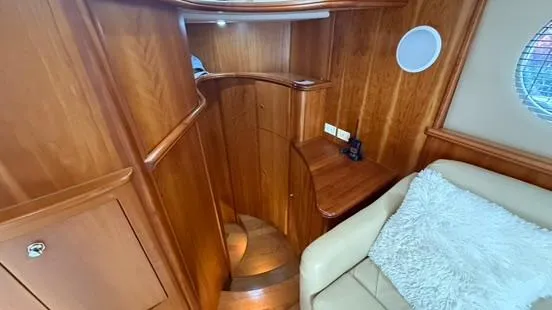 Slide: The Image of Interior of 2001 Silverton 410 Sport Bridge with wooden staircase and cozy seating area. - 37
