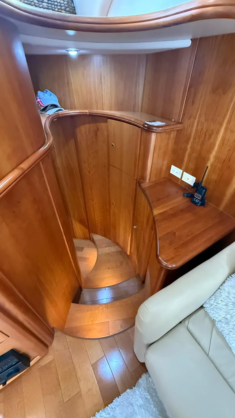 Slide: The Image of Interior of 2001 Silverton 410 Sport Bridge with wooden stairs and cozy seating area. - 38