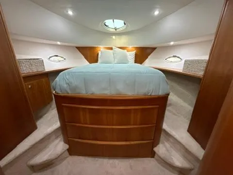 Slide: The Image of Luxurious cabin interior of 2001 Silverton 410 Sport Bridge yacht with cozy bed and wooden accents. - 39