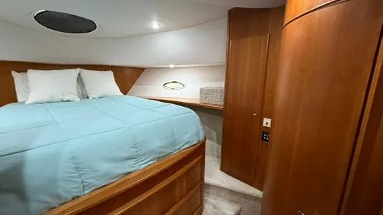 Slide: The Image of Interior cabin of 2001 Silverton 410 Sport Bridge with bed and wooden cabinetry. - 42
