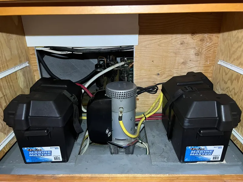 Slide: The Image of 2001 Silverton 410 Sport Bridge battery compartment with marine batteries and wiring. - 44