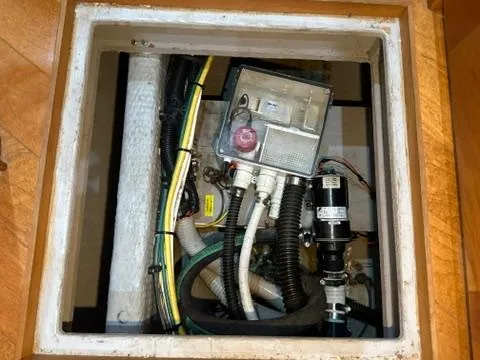 Slide: The Image of Bilge compartment of a 2001 Silverton 410 Sport Bridge with various hoses and electrical components. - 47