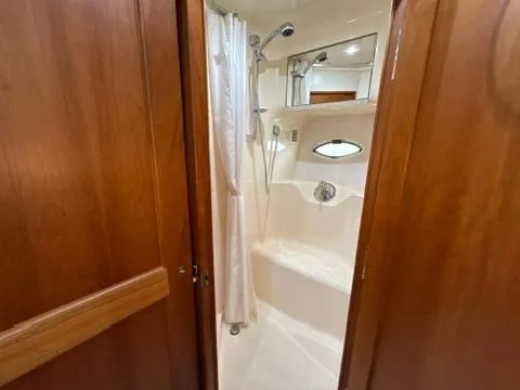 Slide: The Image of Bathroom interior of 2001 Silverton 410 Sport Bridge yacht with shower and wooden accents. - 48