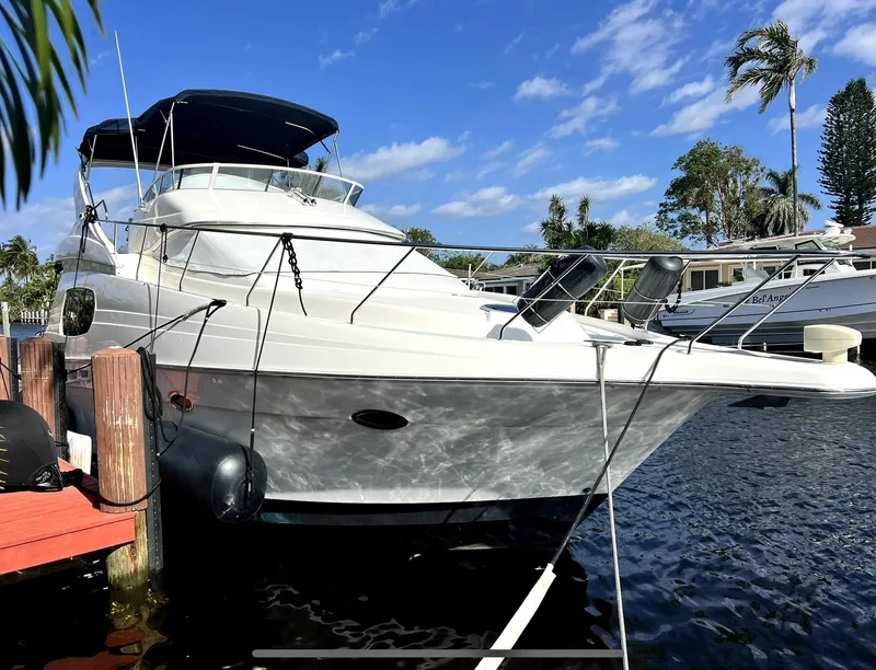Slide: The Image of 2001 Silverton 410 Sport Bridge yacht docked on a sunny day. - 6