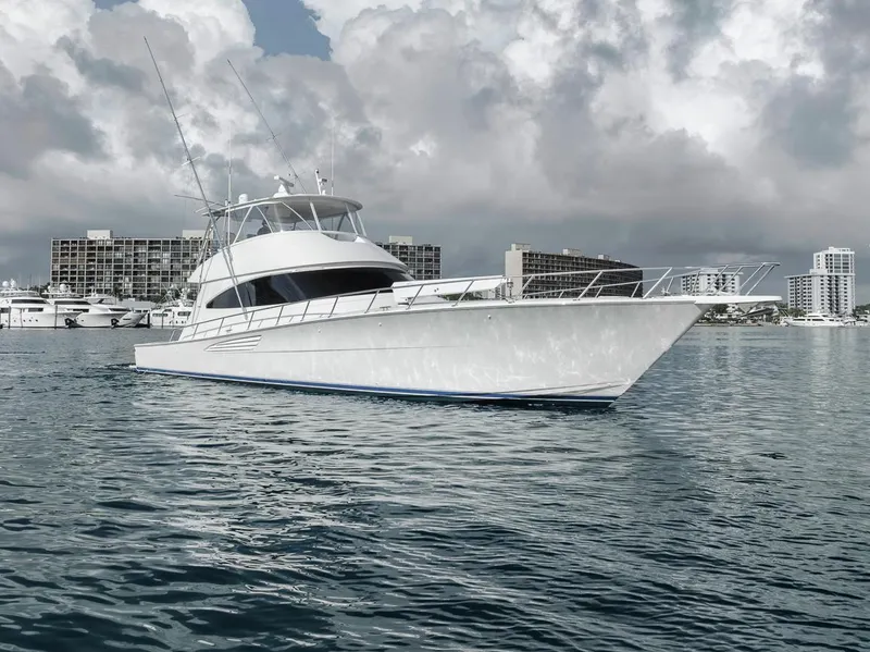 Slide: The Image of 2019 Viking 68 Convertible yacht on calm water with cityscape background. - 10