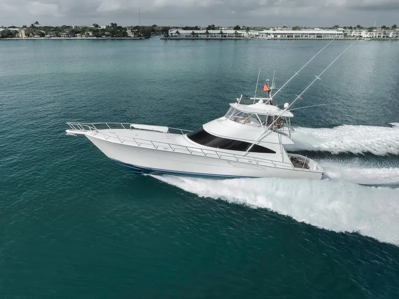 Slide: The Image of 2019 Viking 68 Convertible yacht cruising on calm blue waters. - 13