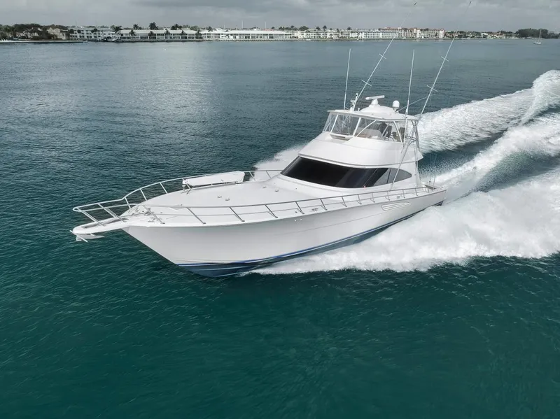 Slide: The Image of 2019 Viking 68 Convertible yacht cruising on clear blue water. - 14