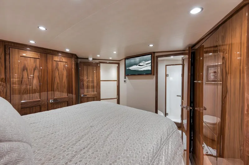 Slide: The Image of Luxurious cabin interior of 2019 Viking 68 Convertible yacht with wood paneling and modern amenities. - 27