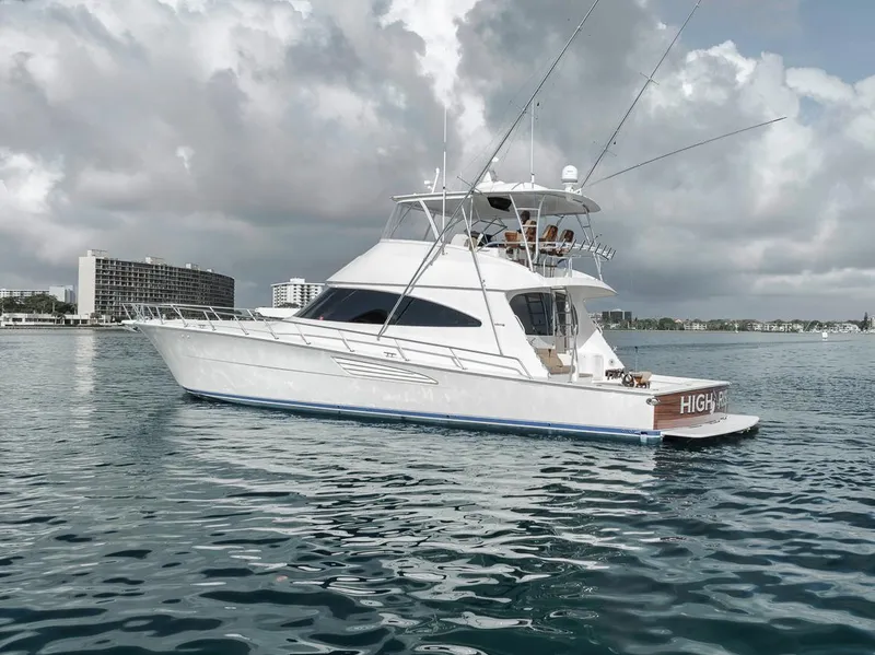 Slide: The Image of 2019 Viking 68 Convertible yacht on calm water under cloudy skies. - 3