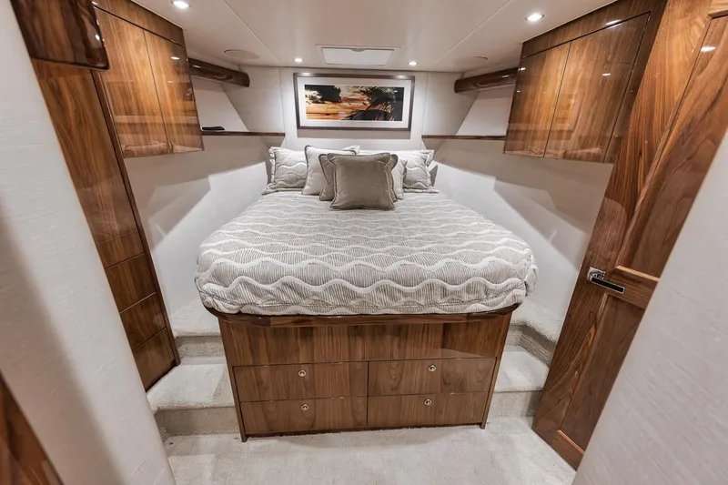 Slide: The Image of Luxurious bedroom interior of 2019 Viking 68 Convertible yacht with wood accents and cozy bedding. - 30