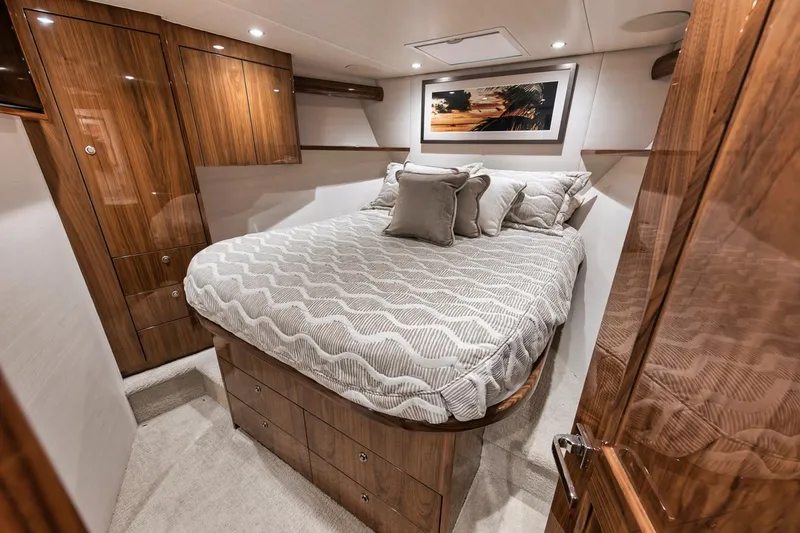 Slide: The Image of Luxurious bedroom interior of 2019 Viking 68 Convertible yacht with elegant wood finishes. - 31