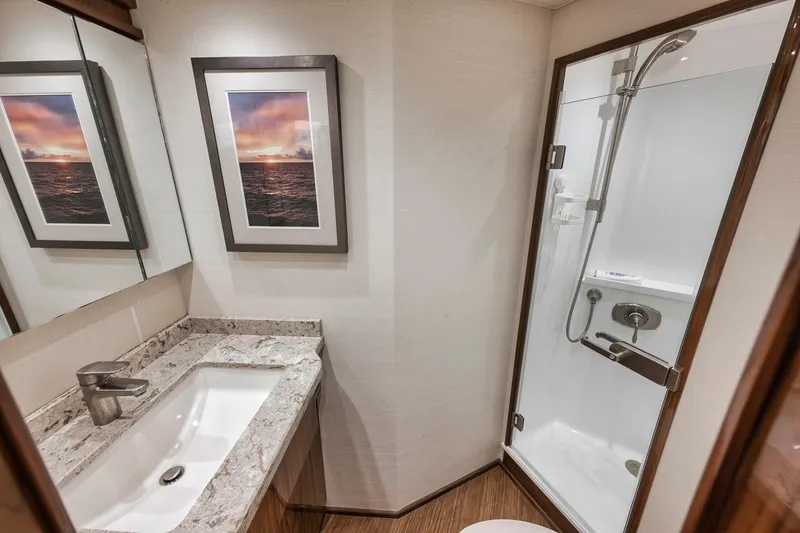 Slide: The Image of Luxurious bathroom in 2019 Viking 68 Convertible yacht with modern shower and elegant sink. - 32