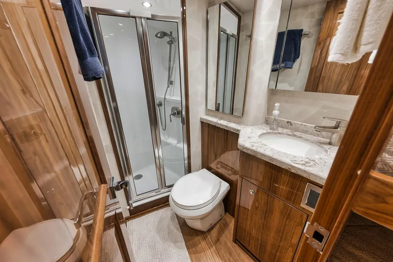 Slide: The Image of Luxurious bathroom in 2019 Viking 68 Convertible yacht with shower, sink, and toilet. - 34
