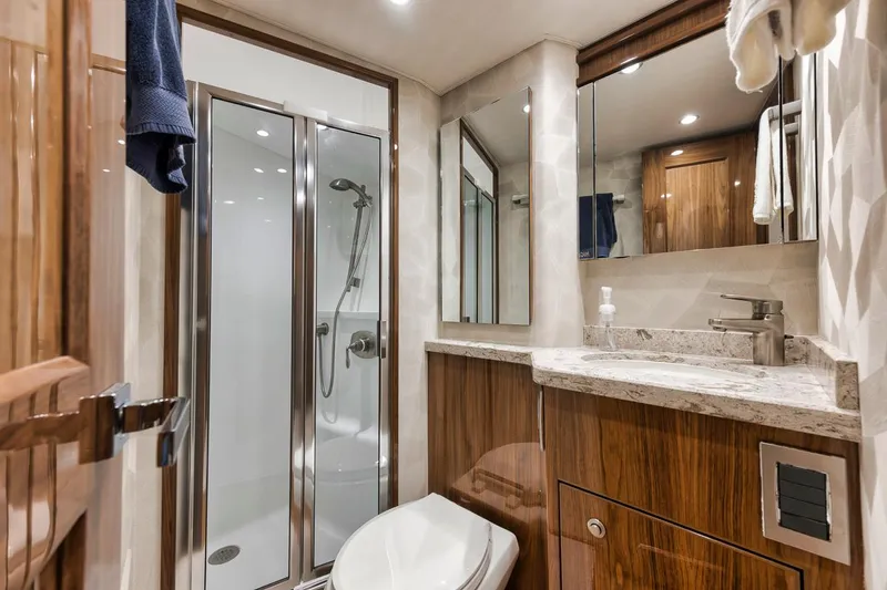 Slide: The Image of Luxurious bathroom in 2019 Viking 68 Convertible yacht with modern fixtures and wood accents. - 35