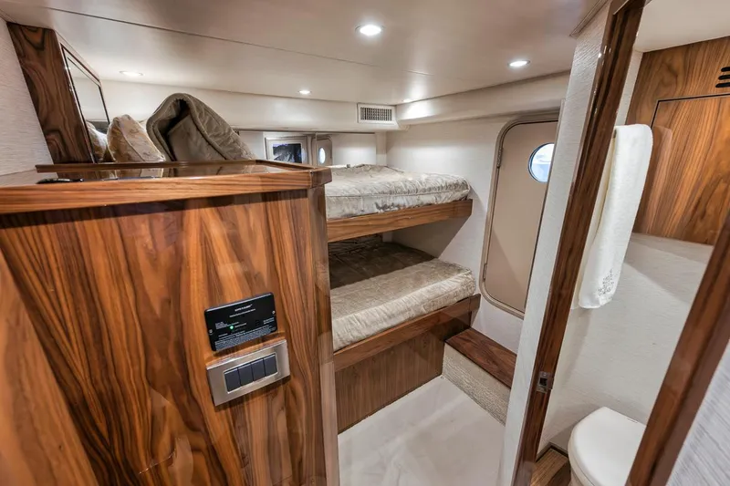 Slide: The Image of Interior of 2019 Viking 68 Convertible yacht with wooden bunk beds and modern design. - 36