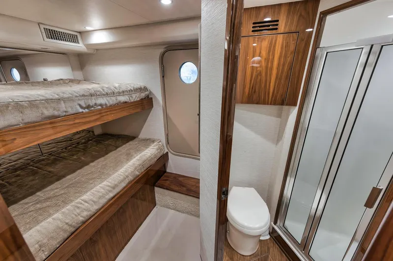 Slide: The Image of Interior of 2019 Viking 68 Convertible yacht with bunk beds and bathroom. - 37