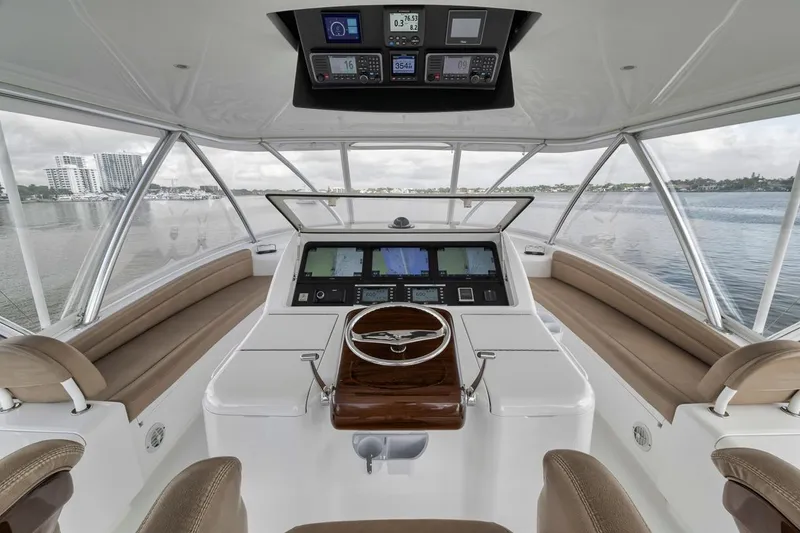 Slide: The Image of 2019 Viking 68 Convertible yacht helm with panoramic water views and advanced navigation systems. - 40