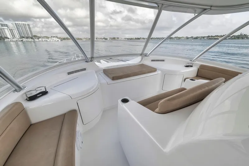 Slide: The Image of 2019 Viking 68 Convertible yacht interior with beige seating and panoramic windows. - 46