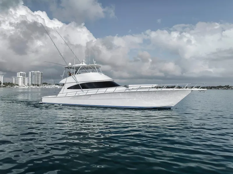 Slide: The Image of 2019 Viking 68 Convertible yacht on calm water with city skyline background. - 8