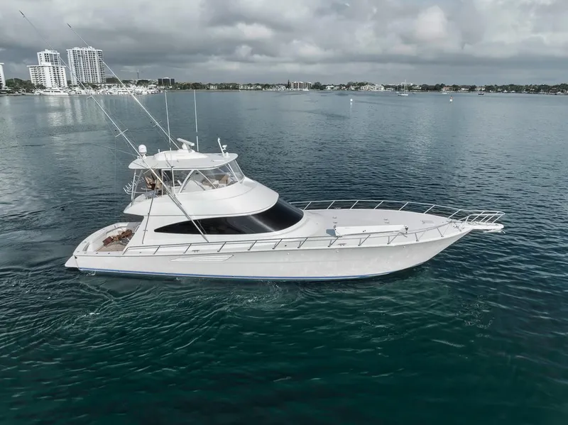 Slide: The Image of 2019 Viking 68 Convertible yacht cruising on calm waters under cloudy skies. - 9