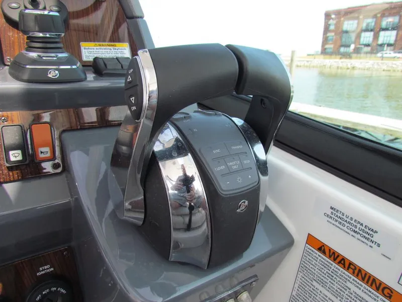 Slide: The Image of Throttle controls on a 2020 Cruisers Yachts 35 Express boat dashboard. - 12