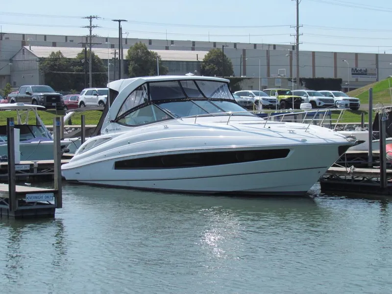 Slide: The Image of 2020 Cruisers Yachts 35 Express docked in a marina, surrounded by calm water. - 13