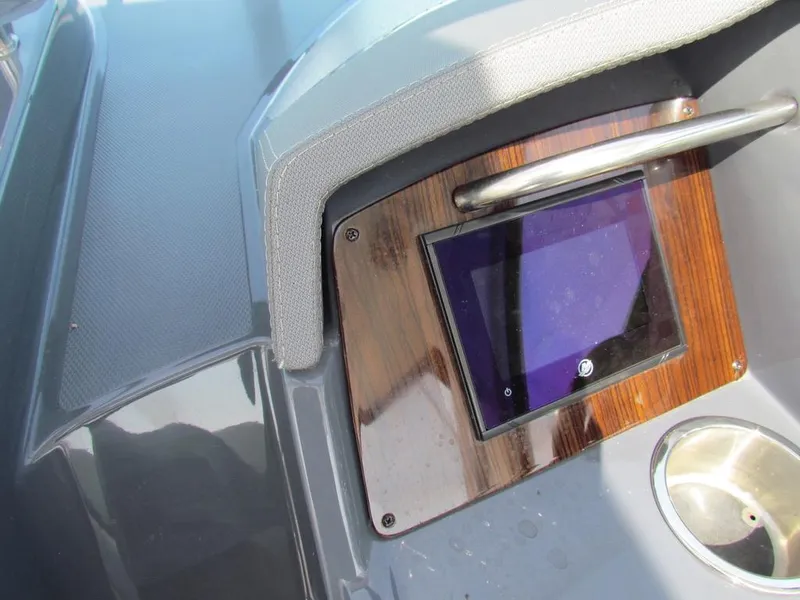 Slide: The Image of Control panel on 2020 Cruisers Yachts 35 Express, featuring a touchscreen and stainless steel accents. - 21