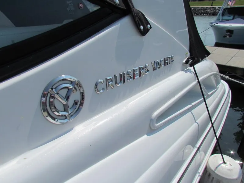 Slide: The Image of 2020 Cruisers Yachts 35 Express, sleek white exterior with logo, docked at marina. - 28